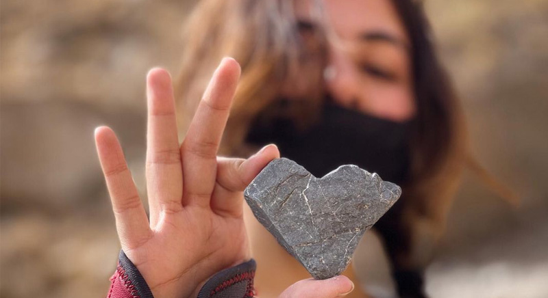 girl holding a heart shaped stone