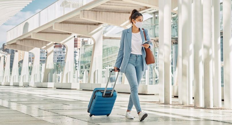 A girl walking with her luggage