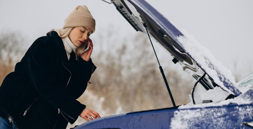 women calling and fixing her car
