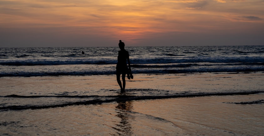 Girl walking at the calm beach