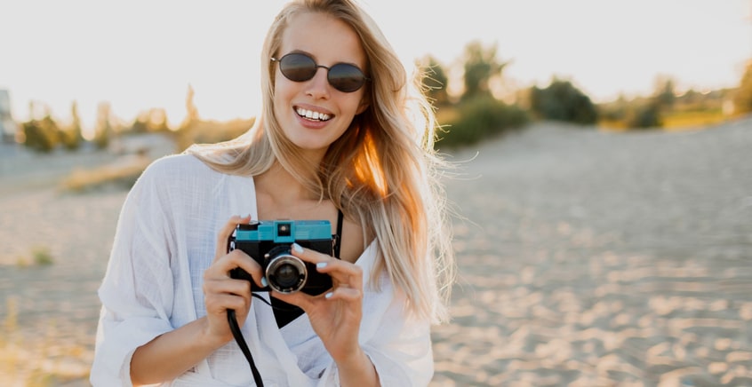 Girl capturing photos at the beach