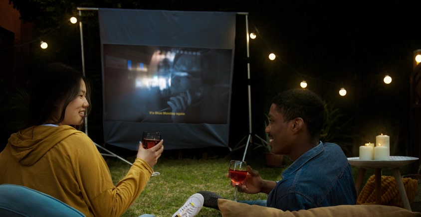 Enjoying outdoor movie night with snacks and drinks
